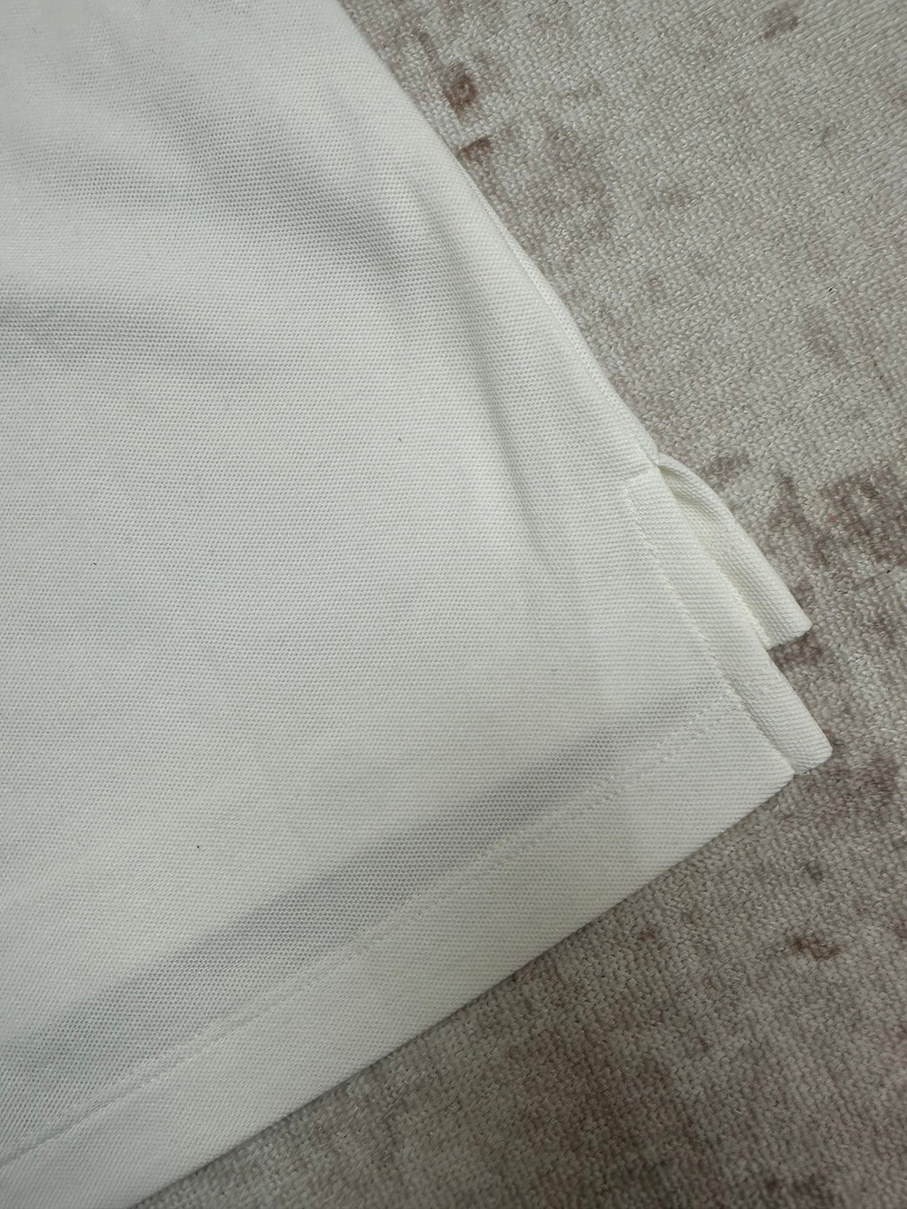 White polo sleeve cuff and side seam
