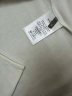 White polo fabric tag near collar and button placket