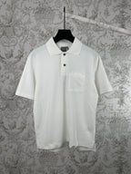 White short-sleeve polo shirt with black buttons and chest pocket