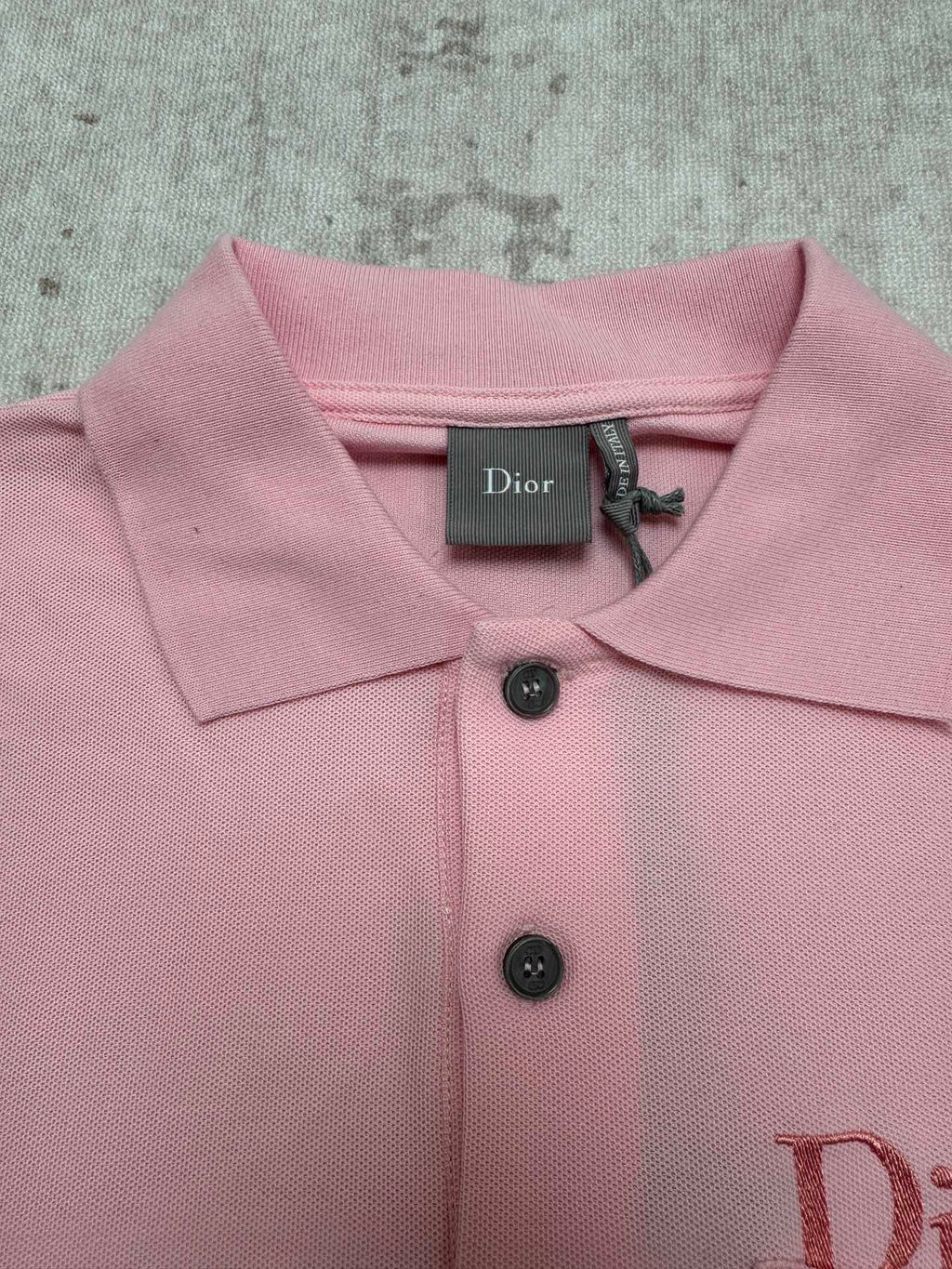 Pink Dior polo shirt collar with button placket and fabric texture detail