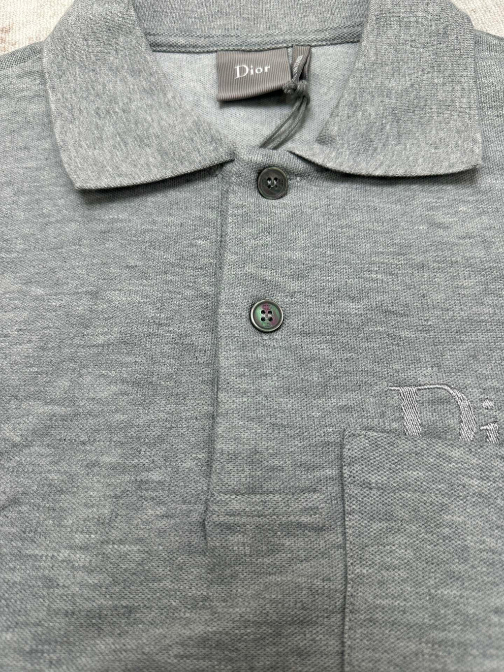 Heather gray polo shirt with button placket and embroidered chest logo