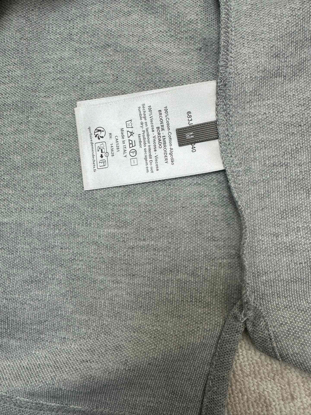 Heather gray polo shirt care label tag inside near side seam
