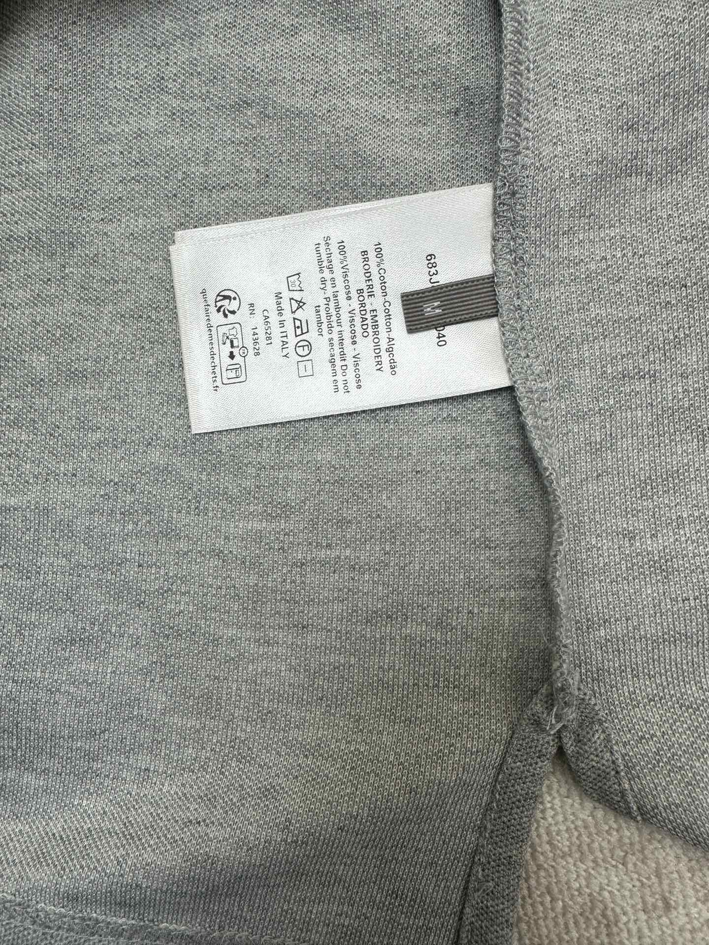 Heather gray polo shirt care label tag inside near side seam
