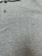 Heather gray polo shirt with chest logo, pocket, and two-button front