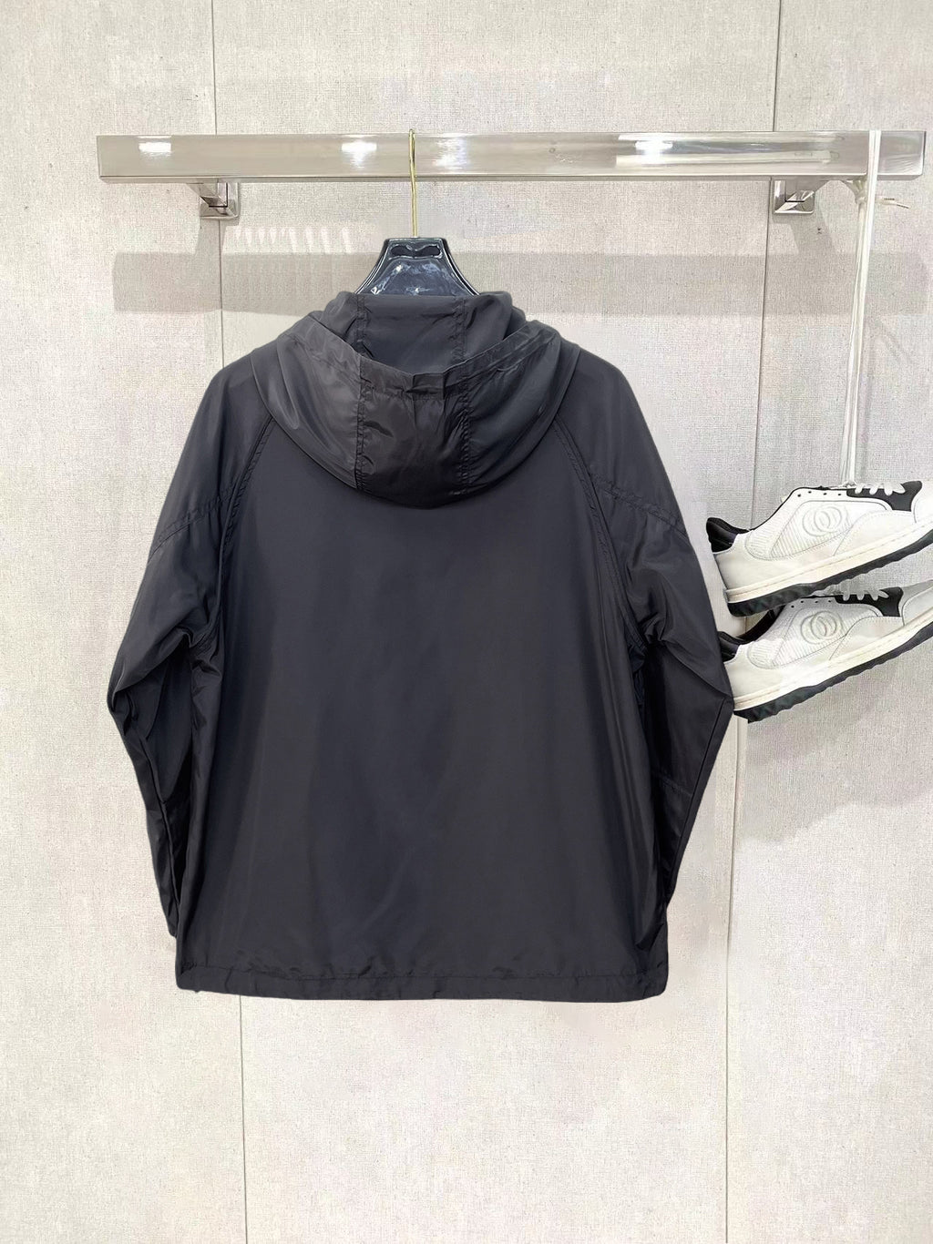 Long hooded zip jacket back view in dark gray, with gathered hood and seam details