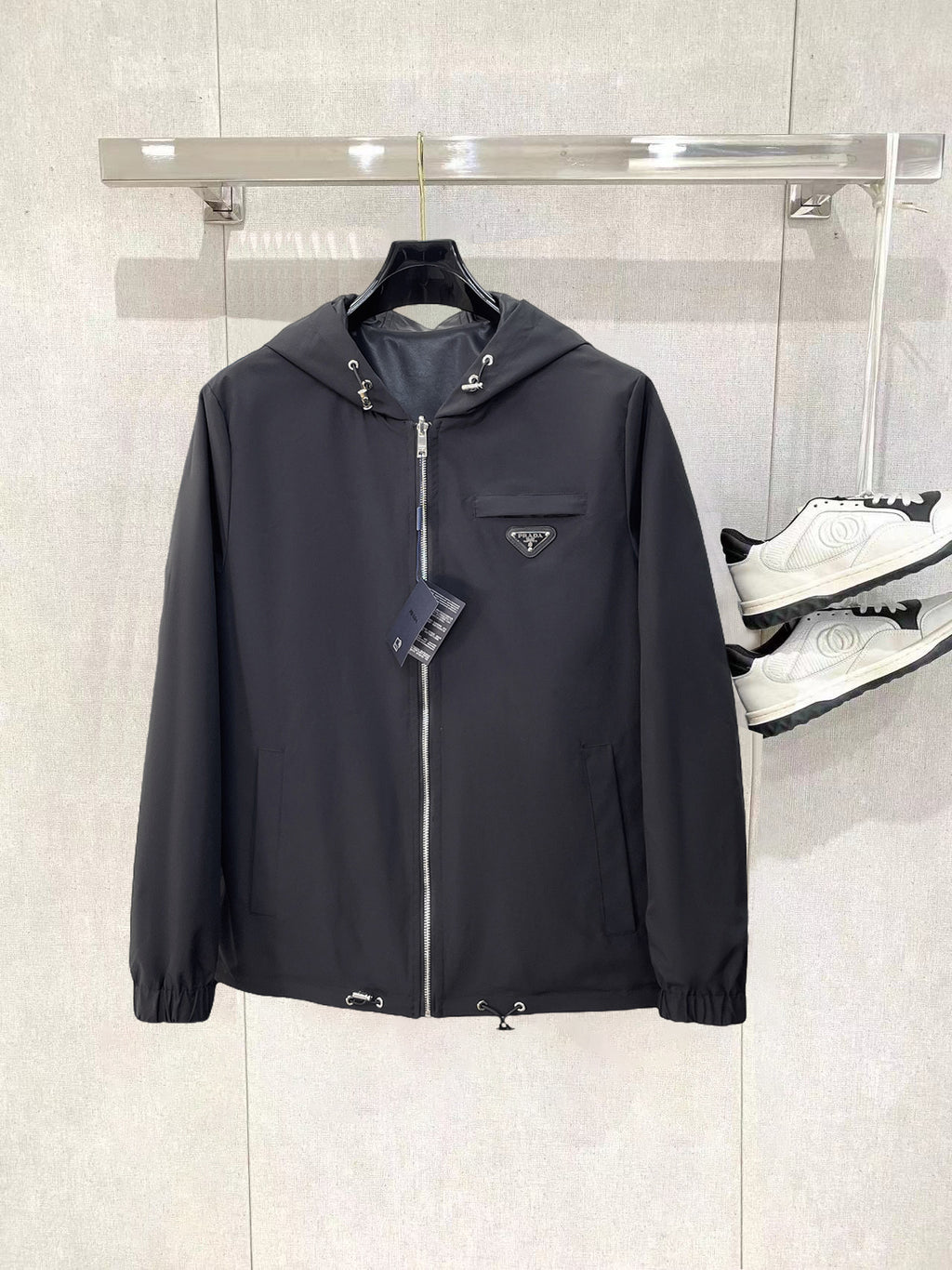 Dark hooded zip jacket with Prada triangle chest logo and drawcord hood