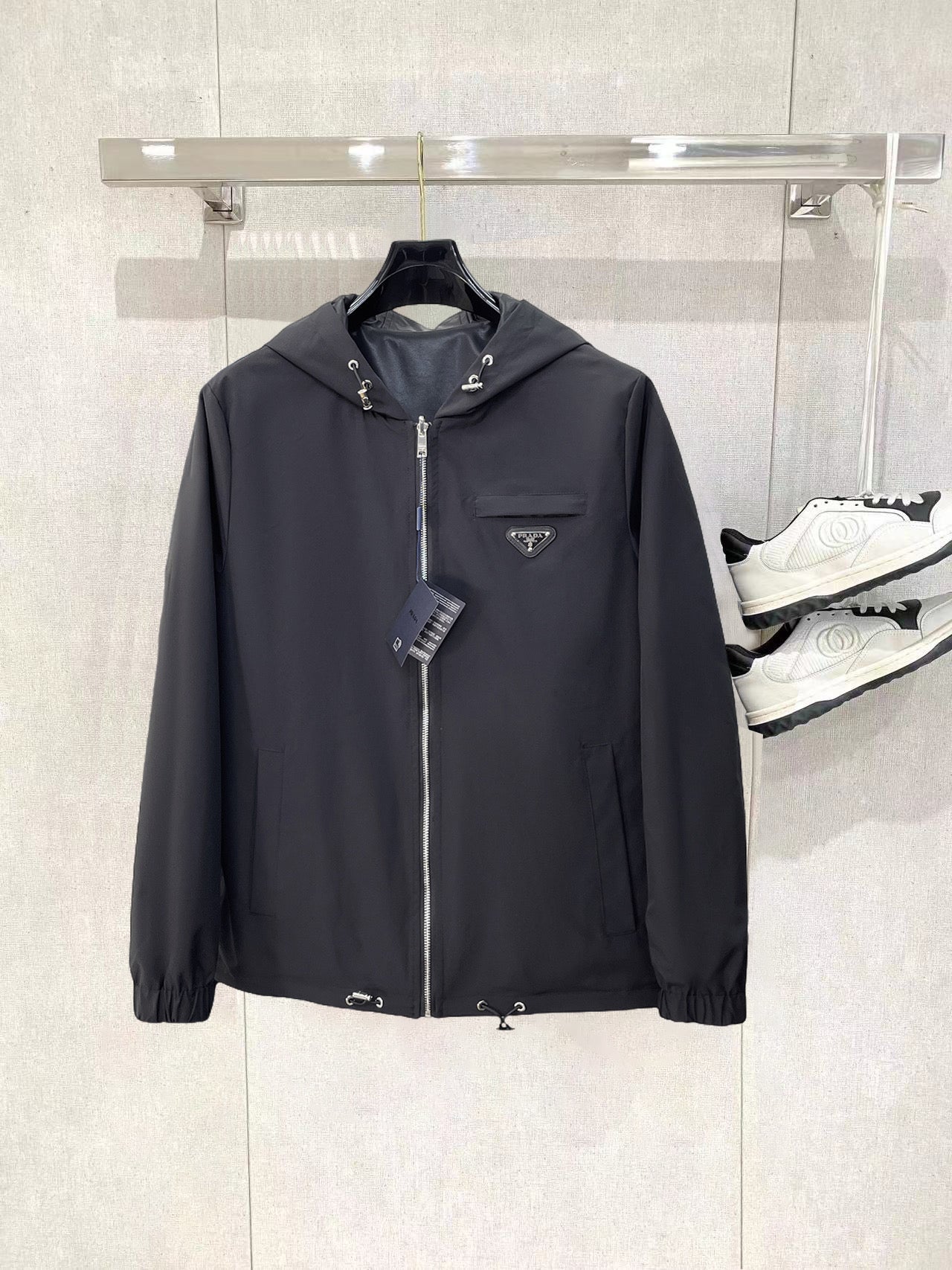 Dark hooded zip jacket with Prada triangle chest logo and drawcord hood