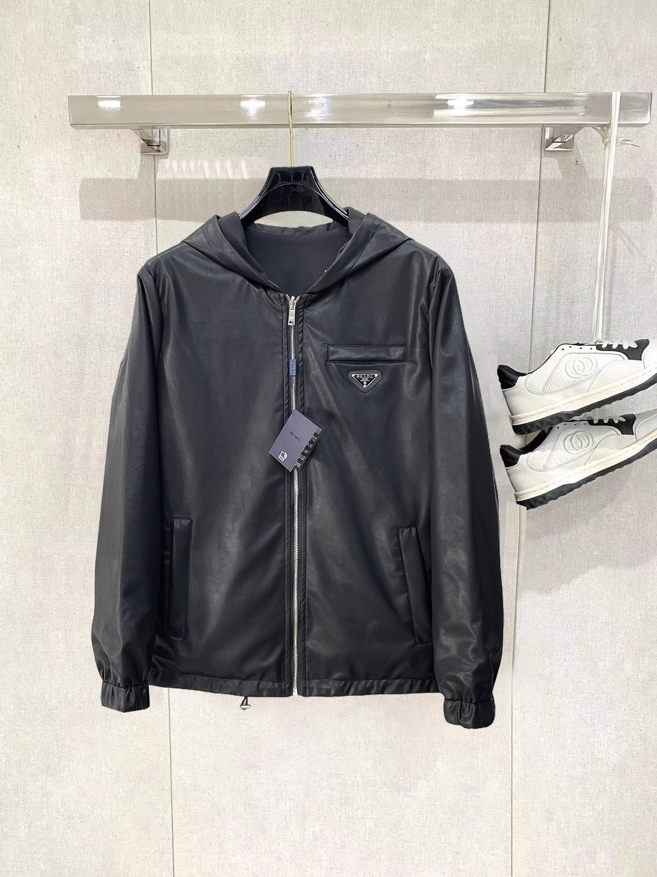 Dark hooded zip jacket with Prada triangle chest logo and front zipper