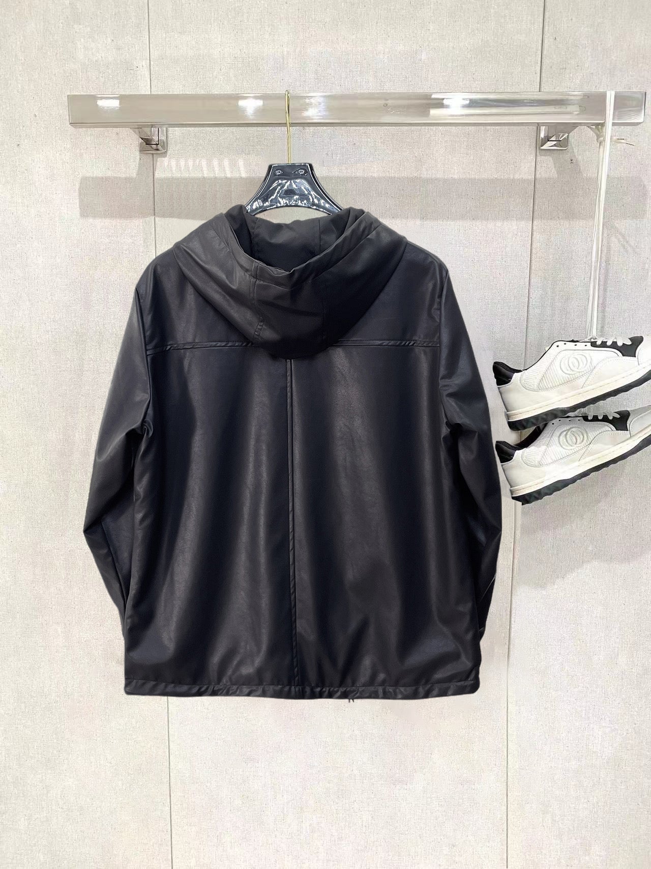 Dark hooded zip jacket rear view with hood and front zipper placket