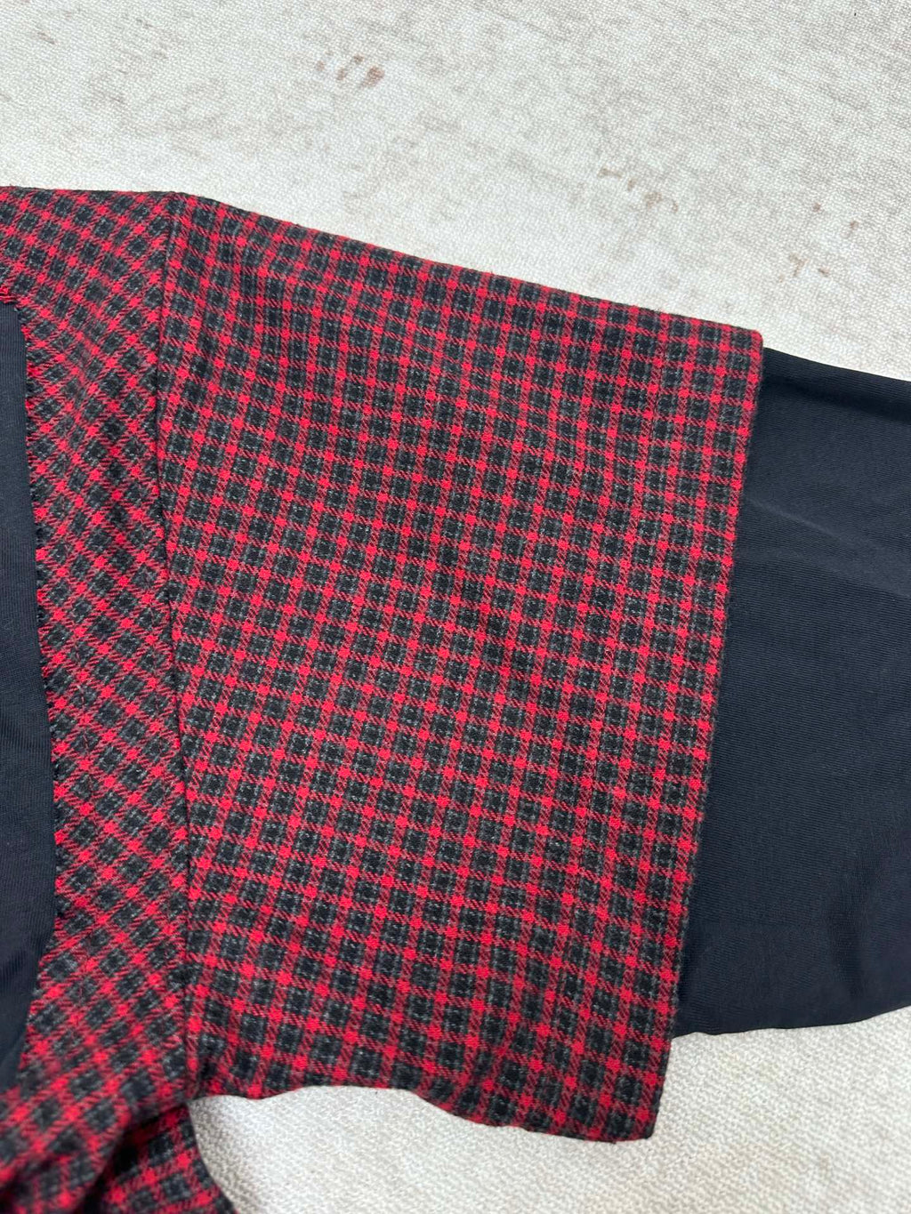 Plaid long-sleeve shirt with flared hem and dark navy underpanel at the side