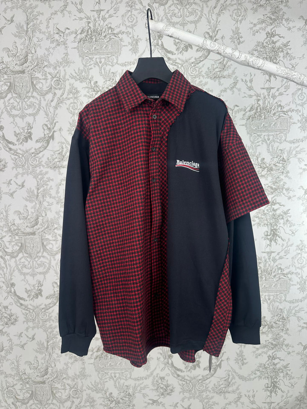 Long-sleeve shirt with red-and-black plaid front, dark navy sleeves, and button-up collar