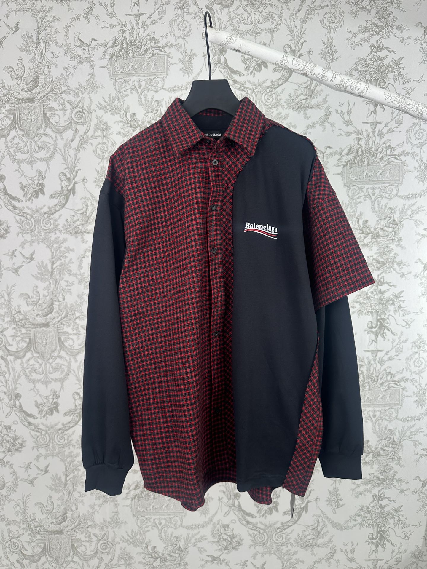 Long-sleeve shirt with red-and-black plaid front, dark navy sleeves, and button-up collar