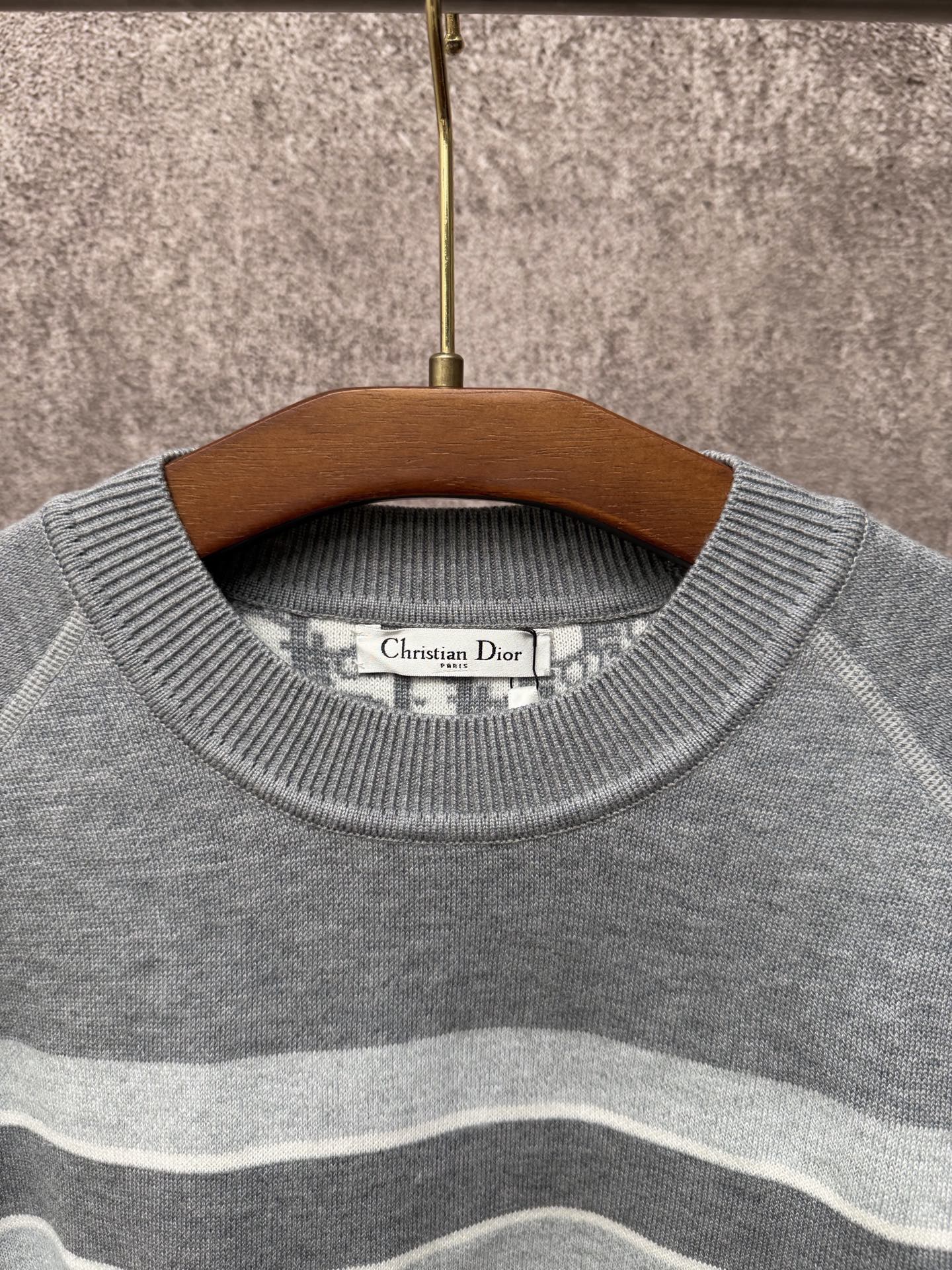 Gray knit sweater crew neck with Christian Dior label and light blue stripes