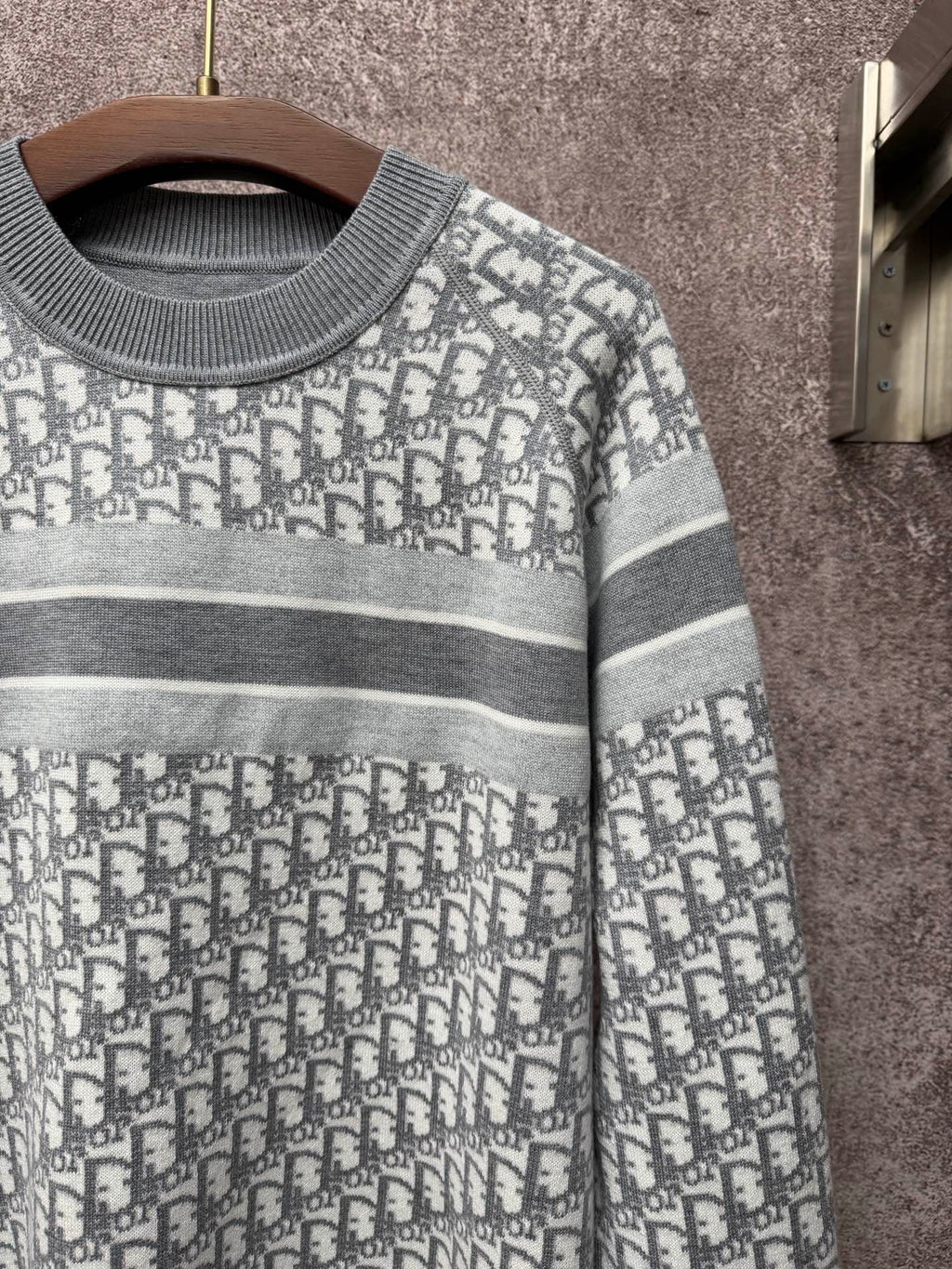 Gray-and-white monogram knit sweater with ribbed crew neck and striped trim