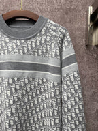 Gray-and-white monogram knit sweater with ribbed crew neck and striped trim