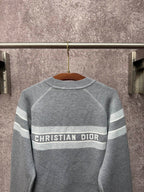 Gray long-sleeve knit sweater with Christian Dior logo band and horizontal stripes