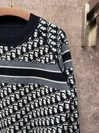 Black and white jacquard knit sweater with striped band and logo repeat pattern