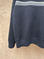 Navy long-sleeve knit sweater with light gray top stripe band visible