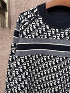 Black and white logo-pattern knit sweater with horizontal stripe bands across chest