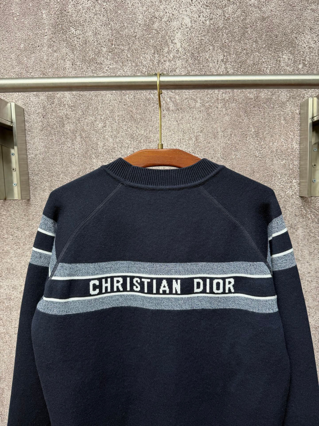 Navy crewneck sweater with striped band and centered "Christian Dior" logo