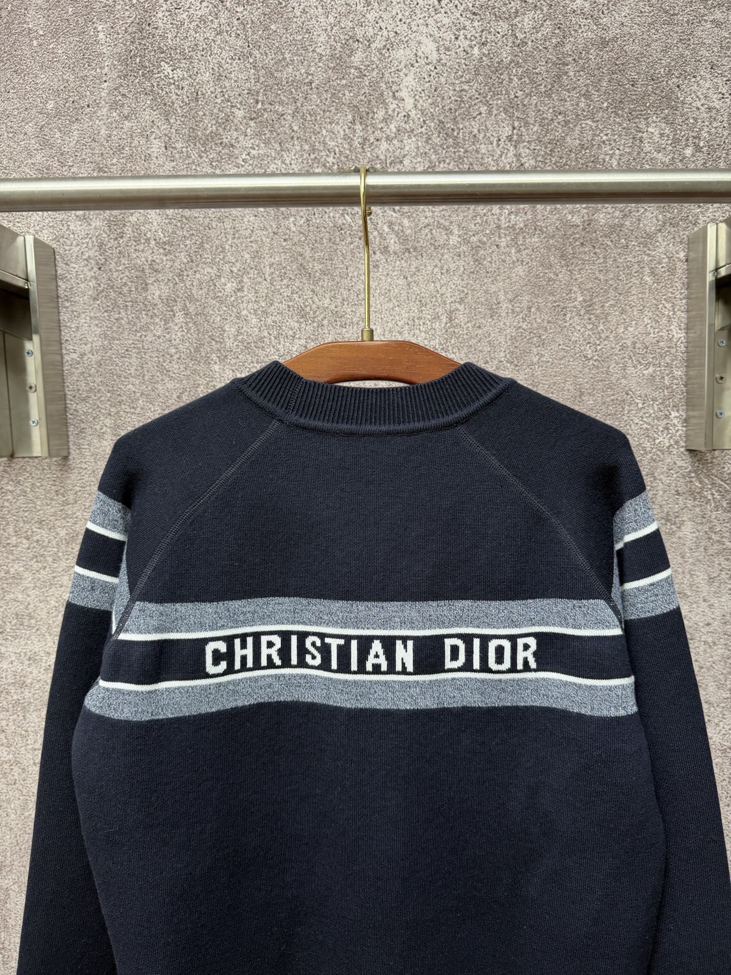 Navy crewneck sweater with striped band and centered "Christian Dior" logo