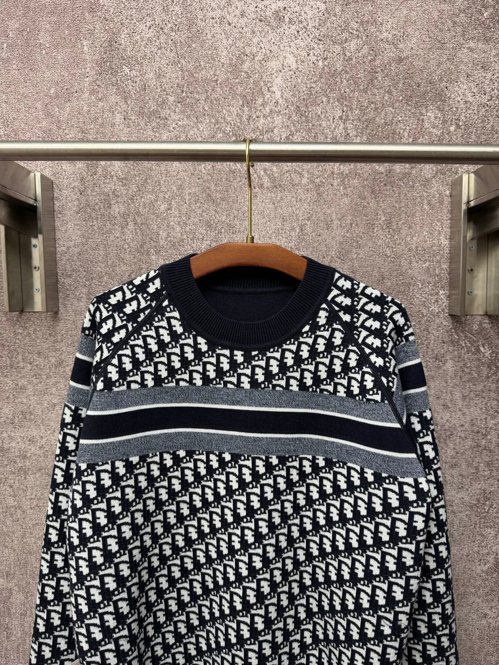 Black and white patterned long-sleeve knit sweater with horizontal stripe bands
