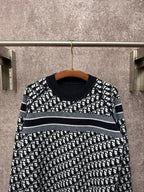 Black and white patterned long-sleeve knit sweater with horizontal stripe bands