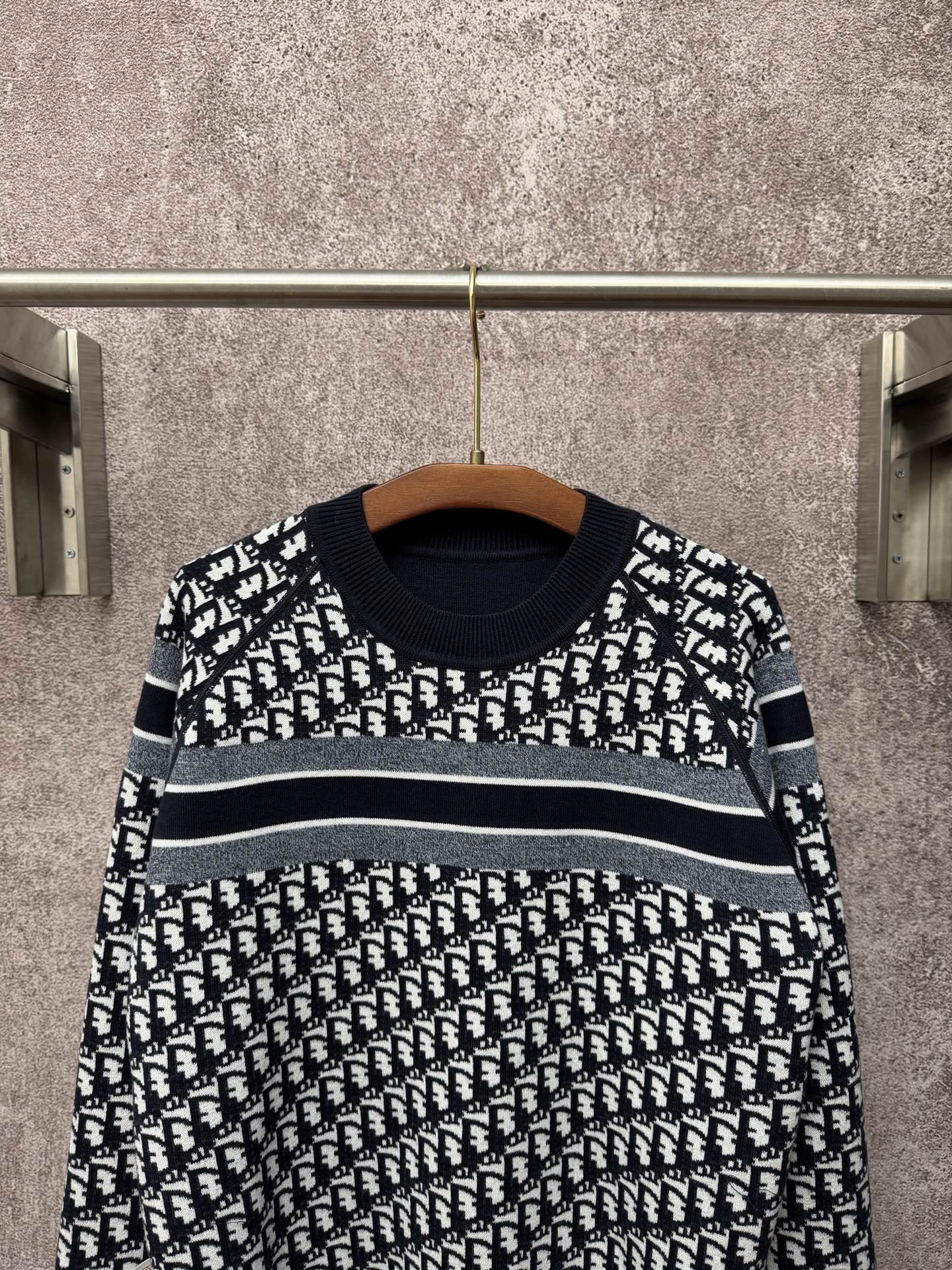 Black and white patterned long-sleeve knit sweater with horizontal stripe bands