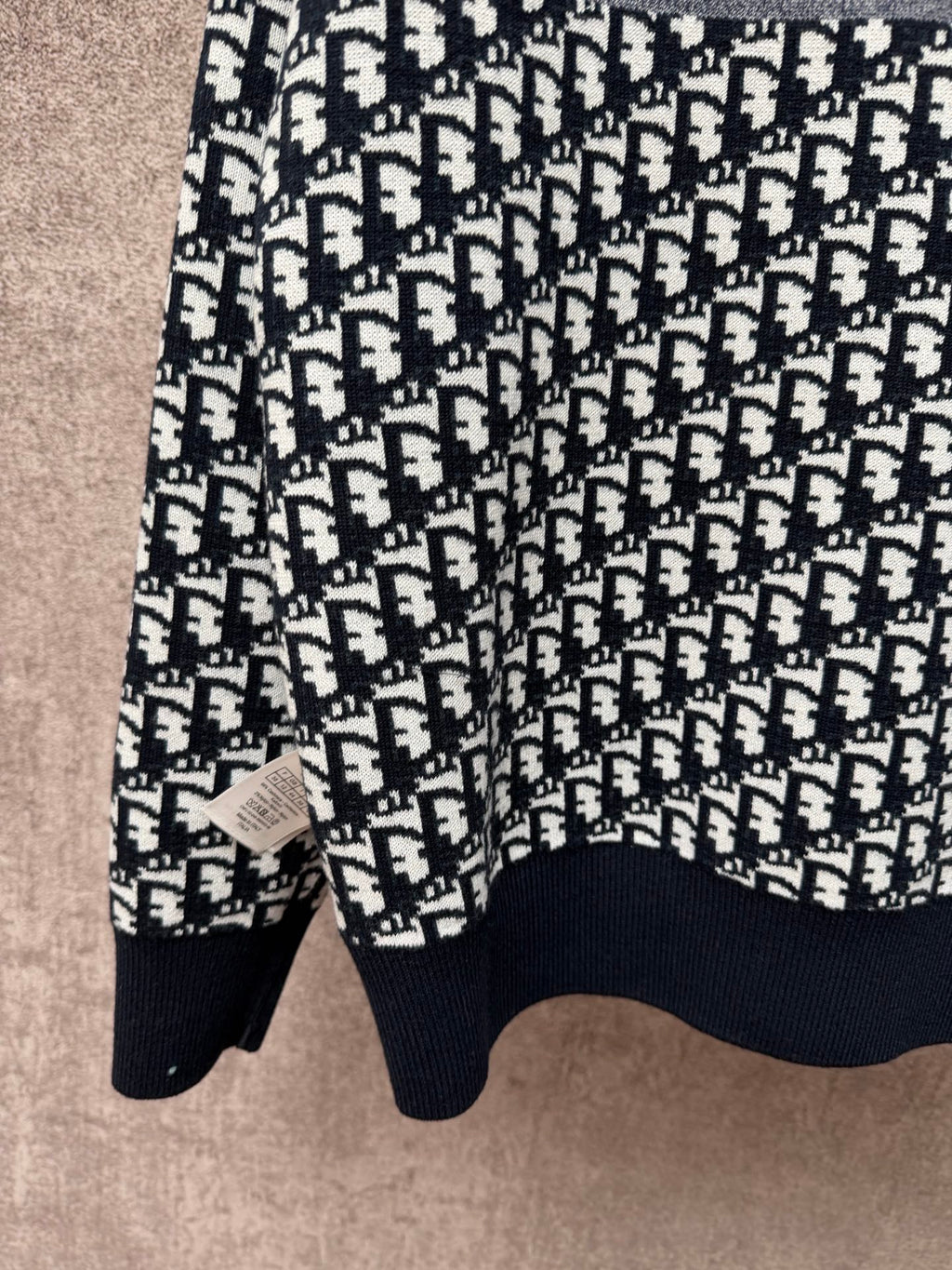 Long-sleeve knit sweater with repeating logo pattern, crew neckline, ribbed cuffs