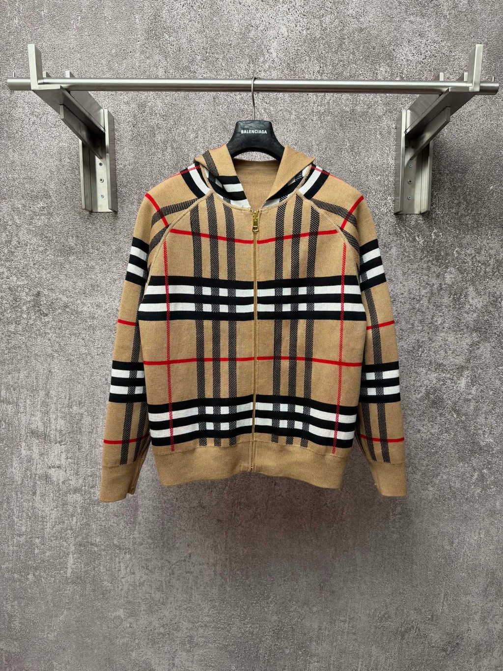 Beige plaid zip-up hoodie with attached hood, gold zipper, black and red stripes pattern