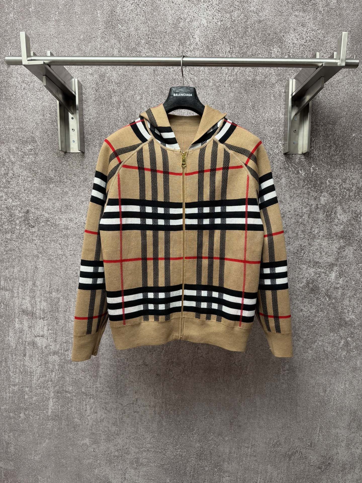 Beige plaid zip-up hoodie with attached hood, gold zipper, black and red stripes pattern