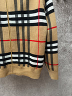 Beige sleeve detail of plaid zip-up hoodie with black stripes and red line accents