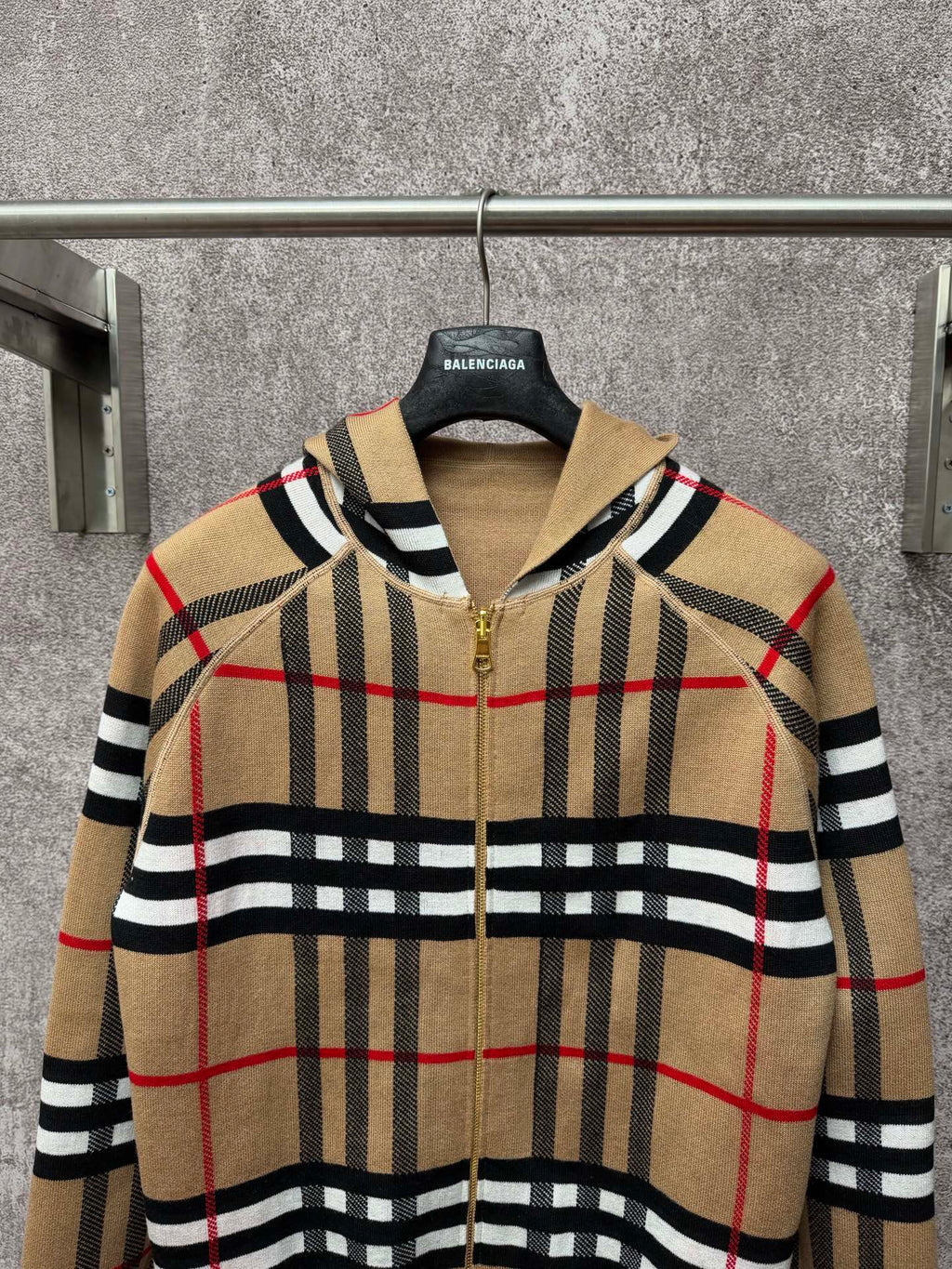 Beige plaid zip-up hoodie with attached hood, gold zipper, black and red grid stripes