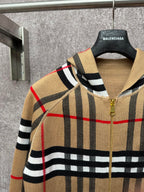 Beige plaid zip-up hoodie detail with gold zipper, black and red grid stripes