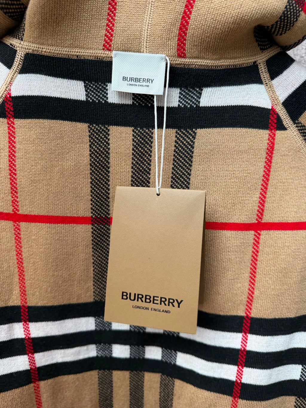 Burberry check polo shirt with red and black stripes, beige and white hem tag