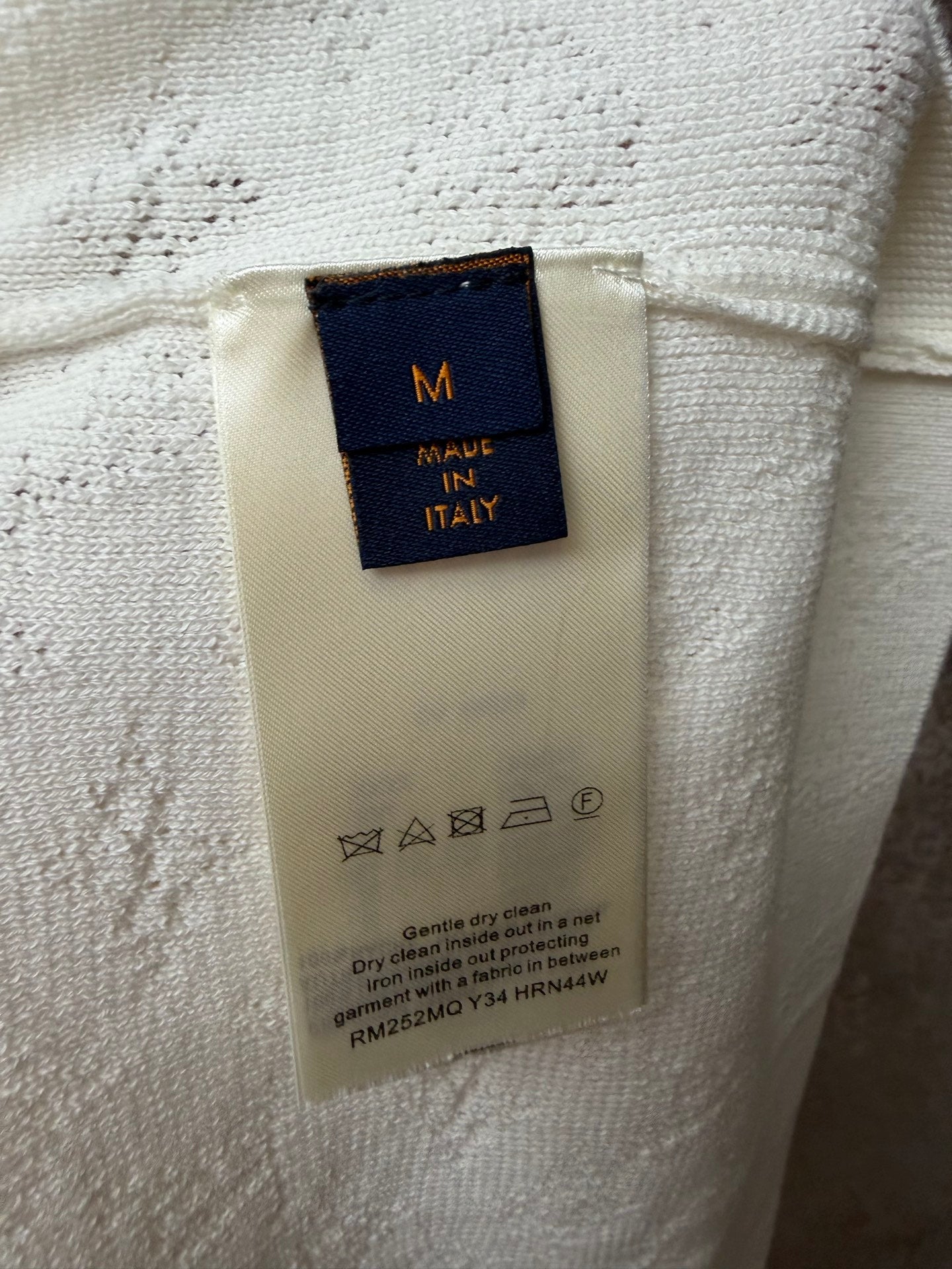 Cream care label with MADE IN ITALY and washing instructions