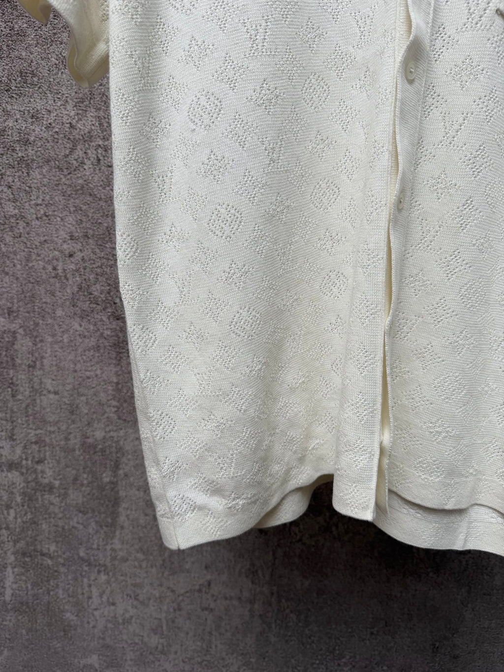 Cream polo shirt back hem with textured monogram fabric