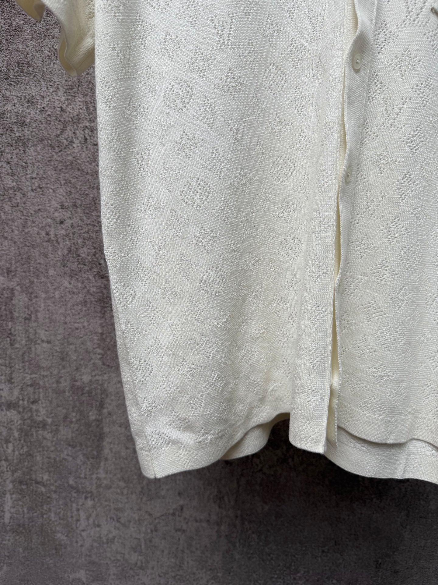 Cream polo shirt back hem with textured monogram fabric