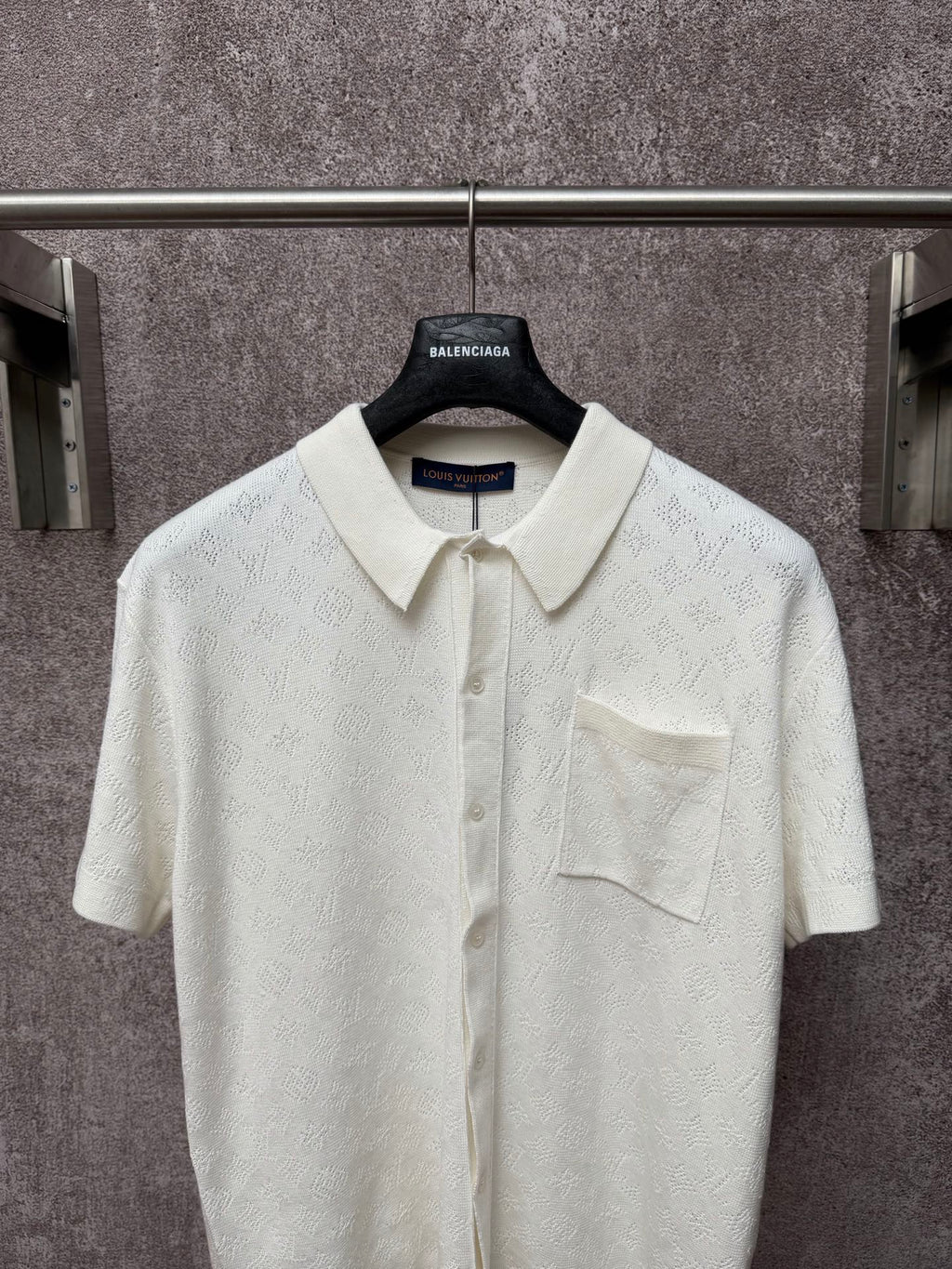 Off-white polo shirt with point collar, front button placket, and chest pocket