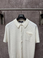 Off-white polo shirt with point collar, front button placket, and chest pocket