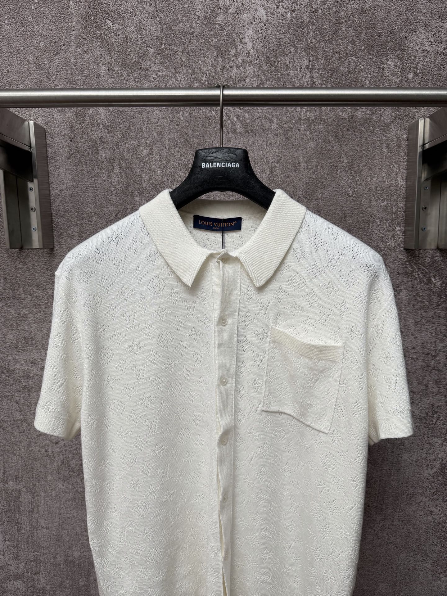 Off-white polo shirt with point collar, front button placket, and chest pocket