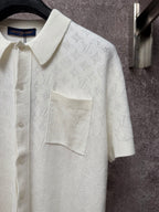 Cream polo shirt with textured monogram pattern, point collar, and flap chest pocket