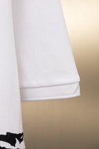 White Burberry polo shirt sleeve hem with black graphic at cuff