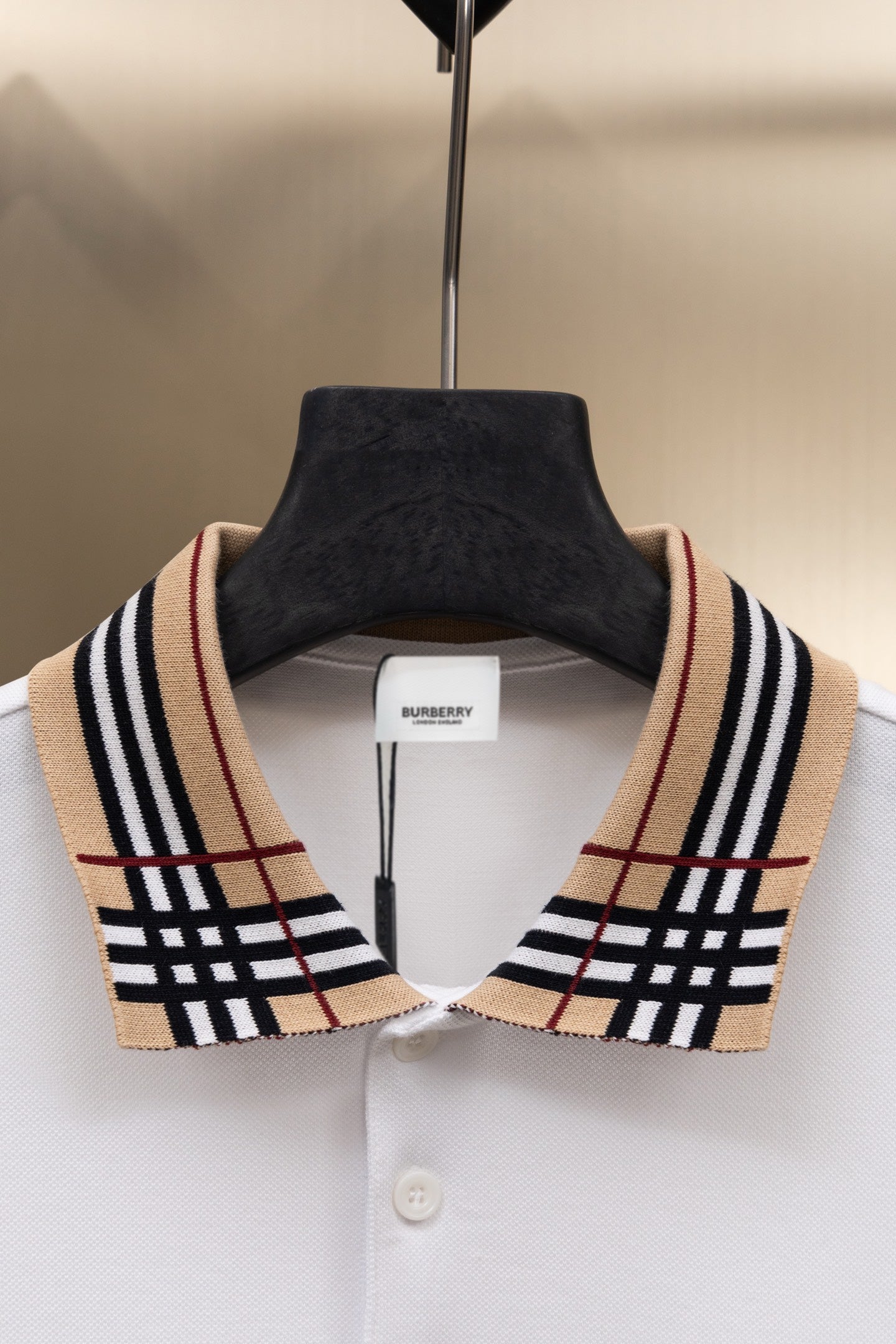 White Burberry polo shirt with check-collar trim and white button placket