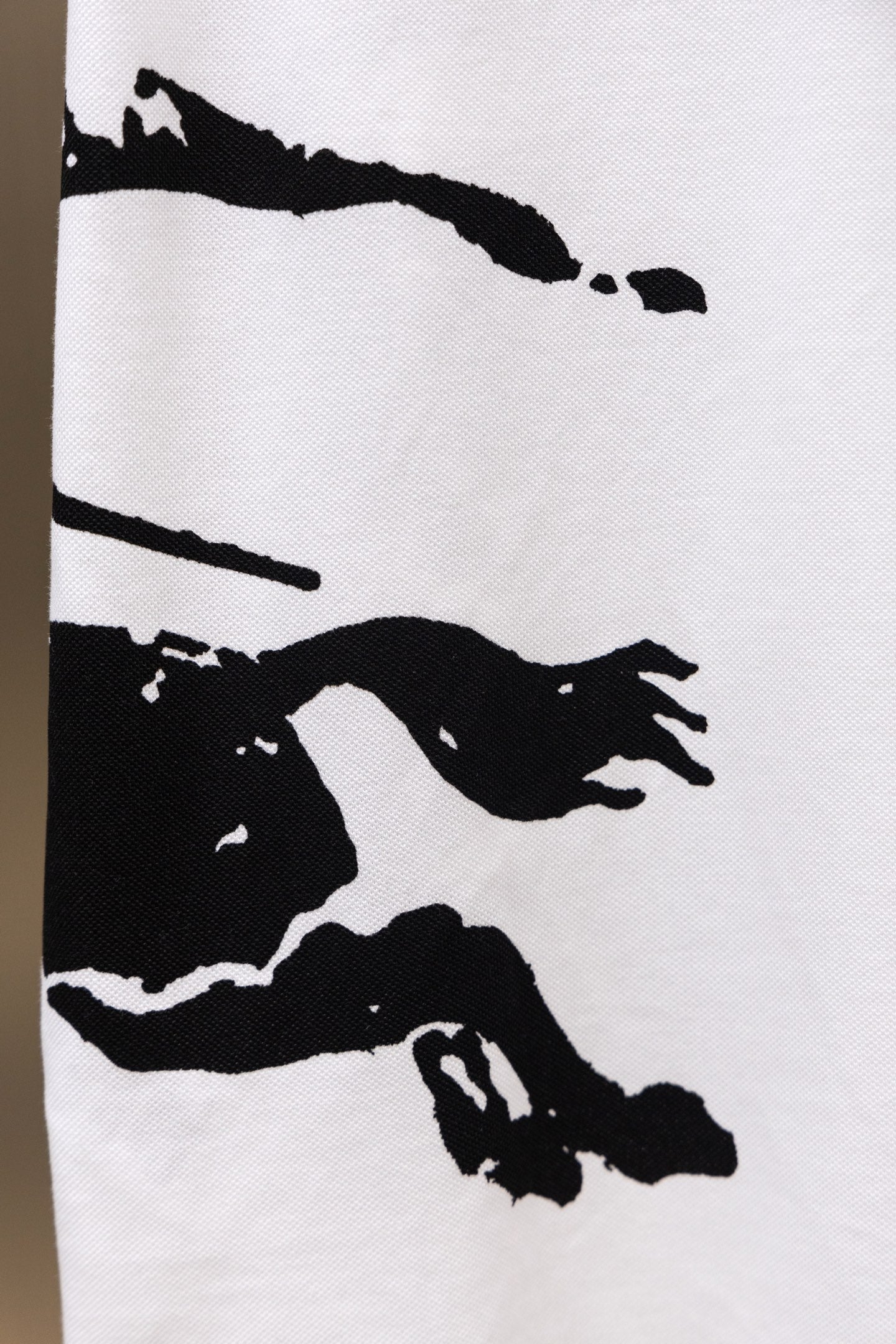White Burberry polo shirt with black action graphic print