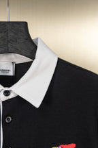 Burberry short-sleeve polo shirt with dark fabric, white collar, button placket