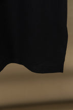Black polo shirt hem at back with curved cut