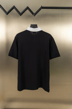 Black polo shirt with white ribbed collar and short sleeves