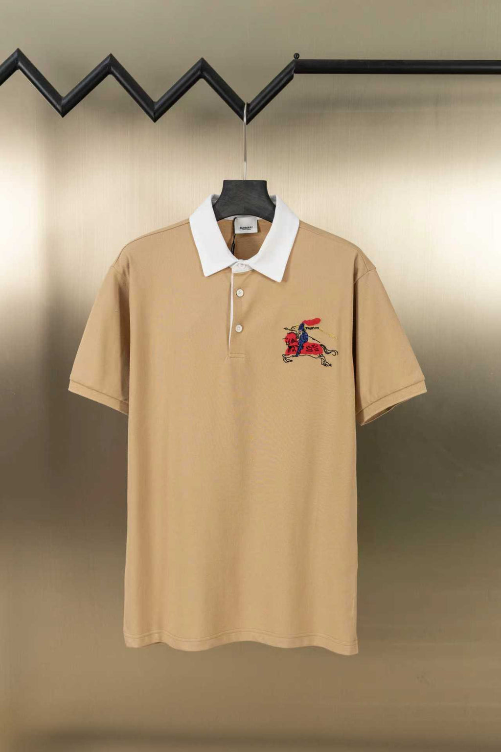 Tan short-sleeve polo shirt with white collar and two-button placket