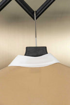 Tan polo shirt neck with white inner collar, back view